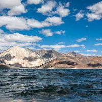 Pangong Tso Tour,Pangong Tso Lake,Leh,scenic route,Chang La Pass,motorable pass,snow-capped mountains,crystal-clear waters,bonfire,accommodation,serene surroundings,leisurely stroll,local cuisine,stunning views,breathtaking beauty,memorable experience,scenic spot,towering peaks,free time,unforgettable memories