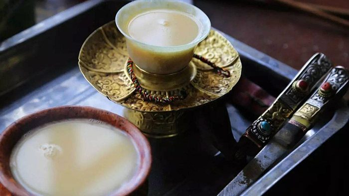 Butter tea served in a metal cup in Ladakh